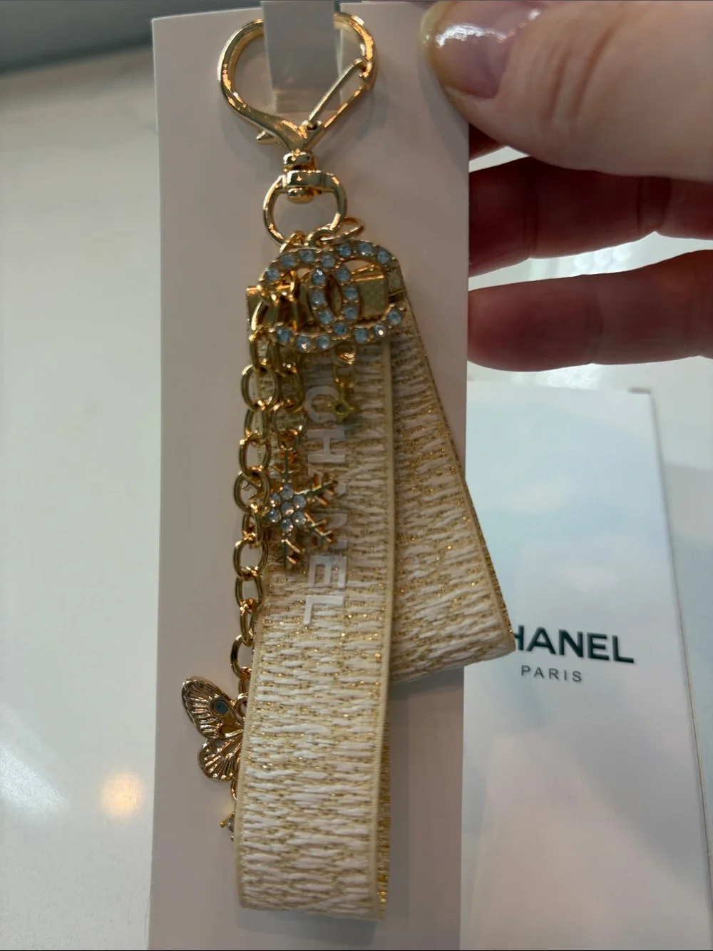 Beige and Gold Logo Strap Keychain with Charms